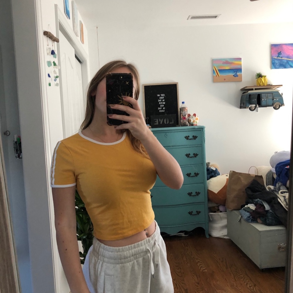 Yellow crop to with white stripes on the sleeves